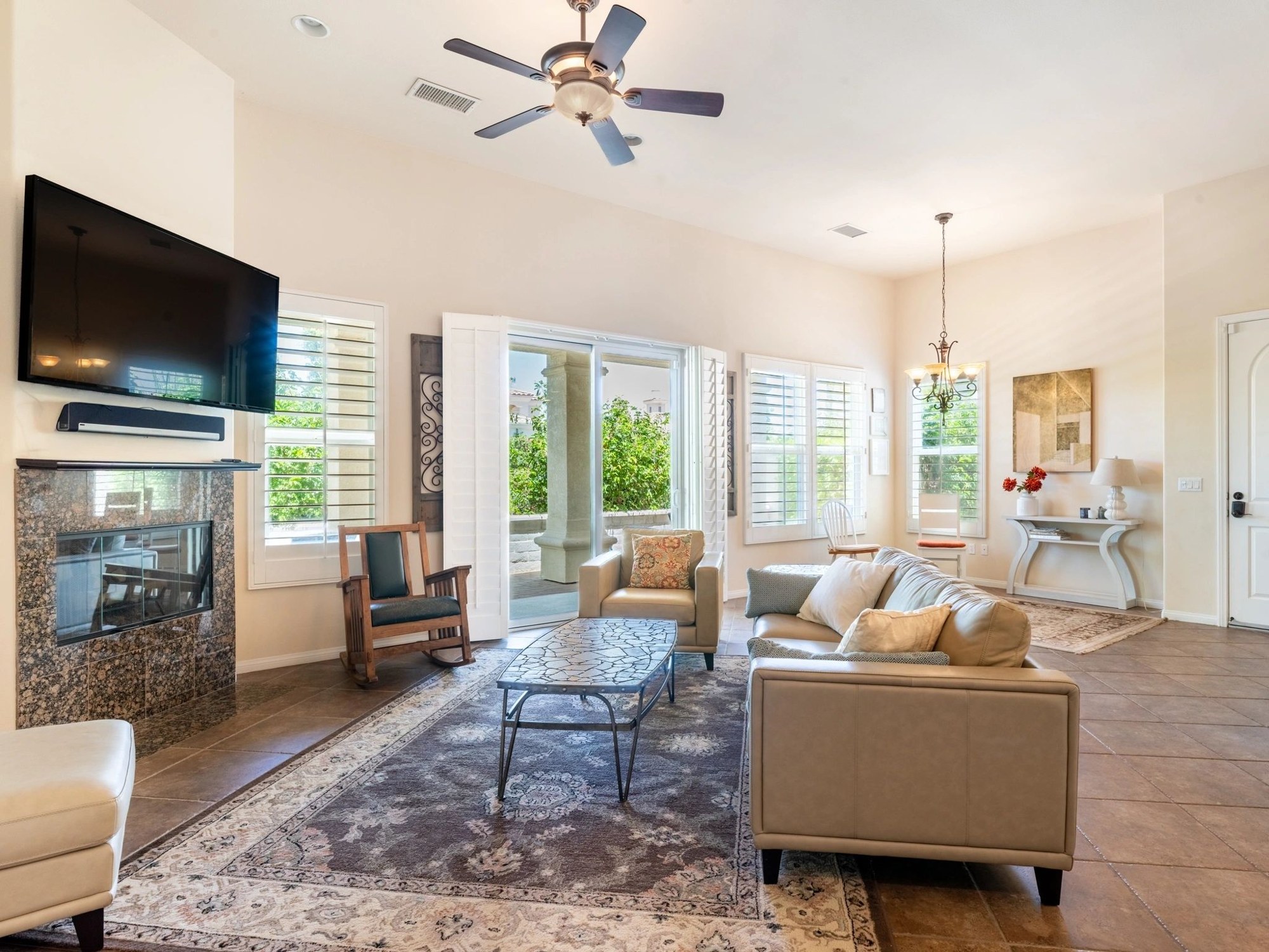 Bright living room with leather sofas and a fireplace